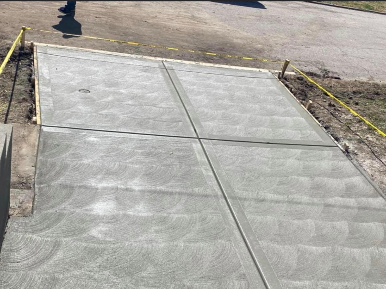 Freshly finished concrete driveway on a Northland home