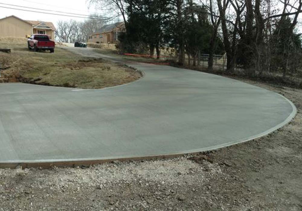 Freshly poured curved residential concrete driveway in Kansas City, MO