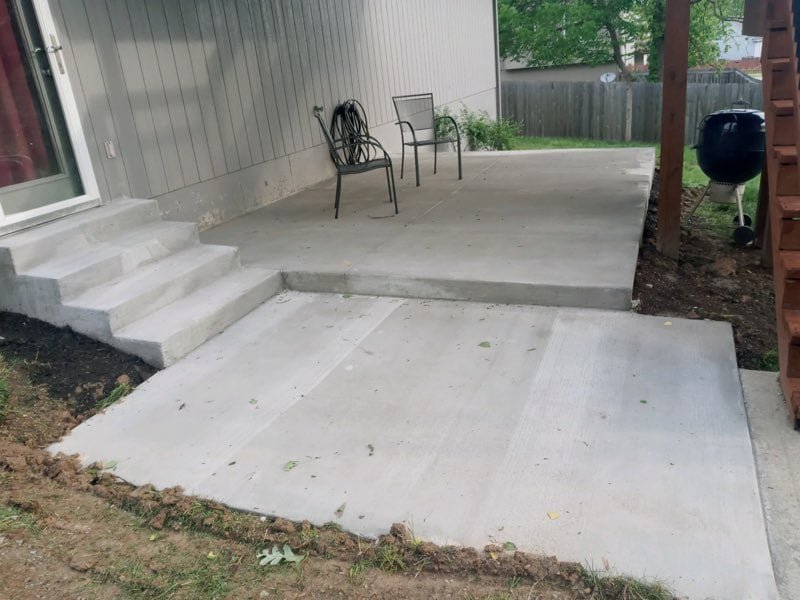 Multi-level concrete patio with steps in a Kansas City metro backyard